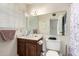 Classic bathroom with wood cabinets, a large mirror, and neutral fixtures at 4957 W Onyx Ave, Glendale, AZ 85302