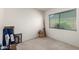 Empty room offering possibilities, featuring a window with blinds and neutral carpet at 4957 W Onyx Ave, Glendale, AZ 85302