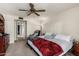 This bedroom features a ceiling fan, carpet and an open doorway at 4957 W Onyx Ave, Glendale, AZ 85302