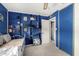 Bright bedroom with blue built-in shelves and closet, complemented by white trim and a comfortable daybed at 4957 W Onyx Ave, Glendale, AZ 85302