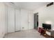 Spare bedroom featuring a closet, neutral carpet, and a door leading to the bathroom at 4957 W Onyx Ave, Glendale, AZ 85302