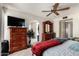 This bedroom features a ceiling fan, a carpet, and wood furniture at 4957 W Onyx Ave, Glendale, AZ 85302