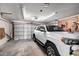 Spacious garage featuring a white SUV, overhead lighting, and ample storage space at 4957 W Onyx Ave, Glendale, AZ 85302