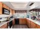 This kitchen features wood cabinets, a sink, and black appliances at 4957 W Onyx Ave, Glendale, AZ 85302
