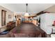 An open kitchen features tile floors, wooden cabinetry and a large table at 4957 W Onyx Ave, Glendale, AZ 85302