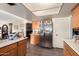 This kitchen features tile floors, wooden cabinetry and stainless steel appliances at 4957 W Onyx Ave, Glendale, AZ 85302