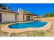 Backyard swimming pool complemented by desert landscaping and a covered patio at 4957 W Onyx Ave, Glendale, AZ 85302