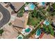 Aerial view of a neighborhood showcasing multiple homes with backyard pools and green landscaping at 6102 E Danbury Rd, Scottsdale, AZ 85254