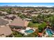 An aerial view showing the neighborhood and backyard pool with the spa and lounge area at 6102 E Danbury Rd, Scottsdale, AZ 85254