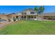 Lush green backyard with covered patio, mature landscaping and ample space for entertaining at 6102 E Danbury Rd, Scottsdale, AZ 85254