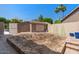 Backyard with storage shed, garden bed, and block wall fence, ideal for gardening enthusiasts at 6102 E Danbury Rd, Scottsdale, AZ 85254