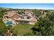 Spacious backyard featuring a pool, lush greenery, and a covered patio perfect for outdoor entertaining at 6102 E Danbury Rd, Scottsdale, AZ 85254