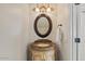 Elegant powder room featuring a marble countertop vanity and decorative lighting at 6102 E Danbury Rd, Scottsdale, AZ 85254