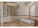 Elegant bathroom with a glass shower and a soaking tub at 6102 E Danbury Rd, Scottsdale, AZ 85254