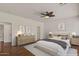 Bright bedroom featuring a ceiling fan, neutral tones, and warm wood flooring and staged decor at 6102 E Danbury Rd, Scottsdale, AZ 85254