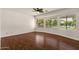 Spacious bedroom with hardwood floors, ceiling fan, and abundant natural light at 6102 E Danbury Rd, Scottsdale, AZ 85254