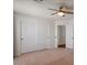 Bedroom with a ceiling fan and closet with sliding doors at 6102 E Danbury Rd, Scottsdale, AZ 85254