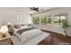 Serene bedroom featuring hardwood floors, large windows with natural light, and neutral decor at 6102 E Danbury Rd, Scottsdale, AZ 85254