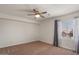 Bedroom featuring a window with sheer curtains and a ceiling fan at 6102 E Danbury Rd, Scottsdale, AZ 85254
