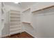 Spacious walk-in closet featuring custom shelving and ample storage space at 6102 E Danbury Rd, Scottsdale, AZ 85254