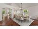 Open concept staged dining room featuring hardwood floors, chandelier, and vaulted ceilings at 6102 E Danbury Rd, Scottsdale, AZ 85254