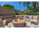 Outdoor fire pit with built-in seating and colorful pillows, ideal for entertaining guests at 6102 E Danbury Rd, Scottsdale, AZ 85254