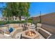 Backyard fire pit with built-in seating in a landscaped setting, great for outdoor gatherings at 6102 E Danbury Rd, Scottsdale, AZ 85254