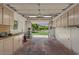 Spacious garage featuring ample storage, shelving, and natural light from an open door at 6102 E Danbury Rd, Scottsdale, AZ 85254