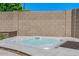 Backyard hot tub is situated against a privacy wall, offering a relaxing retreat at 6102 E Danbury Rd, Scottsdale, AZ 85254
