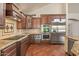 Modern kitchen featuring stainless steel appliances, custom cabinets, and granite countertops at 6102 E Danbury Rd, Scottsdale, AZ 85254
