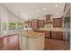 Well-appointed kitchen with granite countertops, stainless steel appliances, and views of the pool at 6102 E Danbury Rd, Scottsdale, AZ 85254