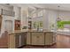 Open concept featuring a kitchen island and fireplace with built-in shelving at 6102 E Danbury Rd, Scottsdale, AZ 85254