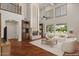 Spacious living room features hardwood floors, fireplace, custom built-ins, and natural light at 6102 E Danbury Rd, Scottsdale, AZ 85254