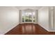 Living room featuring a bay window with natural light and hardwood floors at 6102 E Danbury Rd, Scottsdale, AZ 85254