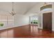 Spacious living room with high ceilings, wood floors, chandelier, and large windows at 6102 E Danbury Rd, Scottsdale, AZ 85254