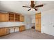 Office space with a built-in desk and upper cabinets for storage at 6102 E Danbury Rd, Scottsdale, AZ 85254