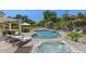 Backyard oasis with a sparkling pool, jacuzzi, lounge chairs, and landscaped surroundings at 6102 E Danbury Rd, Scottsdale, AZ 85254