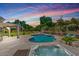 Beautiful pool and spa with covered patio, lush landscaping, and tranquil backyard setting at 6102 E Danbury Rd, Scottsdale, AZ 85254
