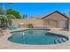 Backyard pool featuring a spa, built in grill, and two chairs at 6102 E Danbury Rd, Scottsdale, AZ 85254