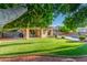 Beautifully landscaped backyard with lush lawn, a sparkling pool, covered patio, and outdoor seating area at 6918 W Villa Hermosa W --, Glendale, AZ 85310