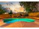 Sparkling pool with ambient lighting surrounded by well-maintained landscaping and a peaceful outdoor setting at 6918 W Villa Hermosa W --, Glendale, AZ 85310