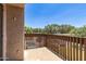 An outdoor balcony overlooking mature trees on a sunny day at 700 E Mesquite Cir # O210, Tempe, AZ 85288