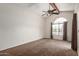 A bright bedroom features a large arched window, vaulted ceilings, and neutral carpet at 700 E Mesquite Cir # O210, Tempe, AZ 85288