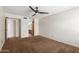 Bedroom with ceiling fan, carpet, and view into ensuite bathroom at 700 E Mesquite Cir # O210, Tempe, AZ 85288