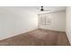 Spacious bedroom with a large window, ceiling fan, and neutral-colored walls at 700 E Mesquite Cir # O210, Tempe, AZ 85288