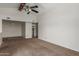 A cozy bedroom with neutral carpet, a closet, and ample natural light from a large window at 700 E Mesquite Cir # O210, Tempe, AZ 85288