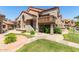 Exterior view of a charming home with a terracotta roof and well-maintained landscaping and lush green grass at 700 E Mesquite Cir # O210, Tempe, AZ 85288