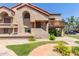 Charming townhome showcasing stucco walls, a terracotta roof, and lush landscaping in a well-maintained community at 700 E Mesquite Cir # O210, Tempe, AZ 85288