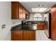 This kitchen offers stainless steel appliances, cherry wood cabinets, and a black countertop at 700 E Mesquite Cir # O210, Tempe, AZ 85288