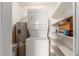 A laundry room with a stackable washer and dryer and open shelving at 700 E Mesquite Cir # O210, Tempe, AZ 85288
